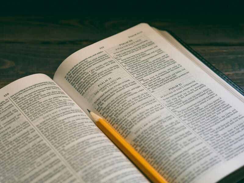 An open Bible with a pencil on the pages of Psalms, symbolizing reflection and study of scripture, including Psalm 45:2.