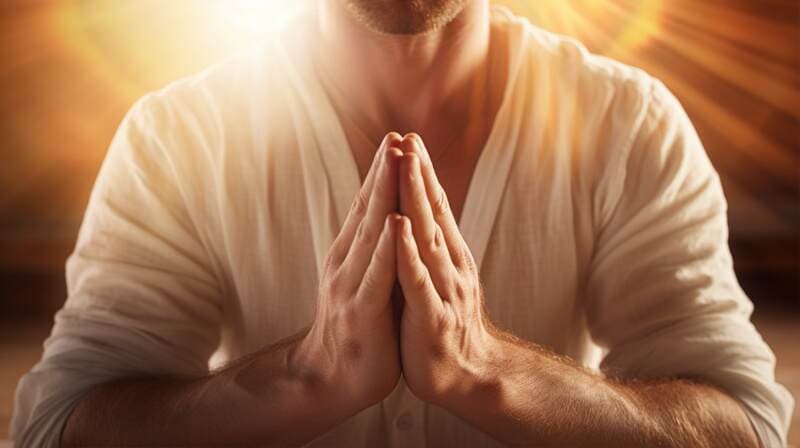 person praying for good luck with the sun light behind